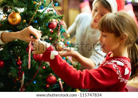 Portrait of happy girl decorating Christmas tree