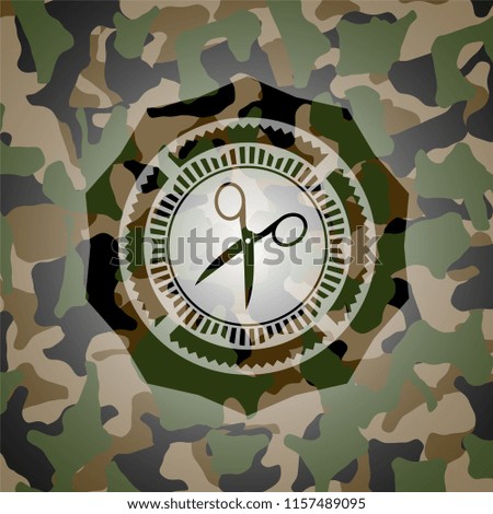 scissors icon inside camouflaged emblem