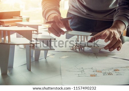 architect design working drawing sketch plans blueprints and making architectural construction model in architect studio Royalty-Free Stock Photo #1157490232