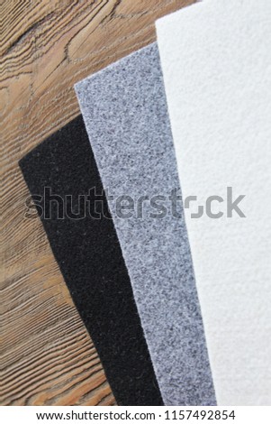 Cloth.
Black, gray and white on a wooden background
