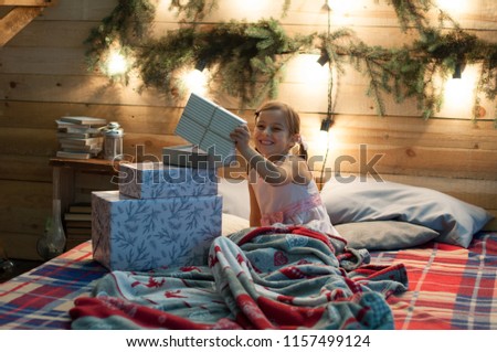 little girl finds Christmas presents
a child unpacks Christmas presents, Christmas gifts in bed