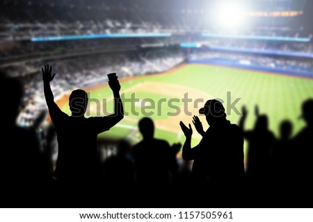 Baseball fans and crowd cheering in stadium and watching the game in ballpark. Happy people enjoying a match and sport event in arena. Friends watching ballgame live. Royalty-Free Stock Photo #1157505961