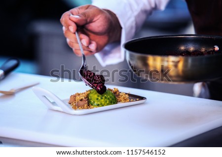 The chef in the kitchen prepares fruit dessert. Close up Royalty-Free Stock Photo #1157546152