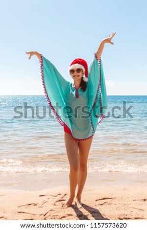 Freedom woman with christmas hat in free happiness bliss on beach.