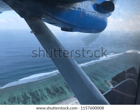 Seaplane view from the window of a maldivian island