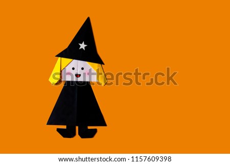 Origami for kids : collection of lady witch from folded paper on orange background isolated.Top view, flat lay.Easy to use for card.Happy halloween.