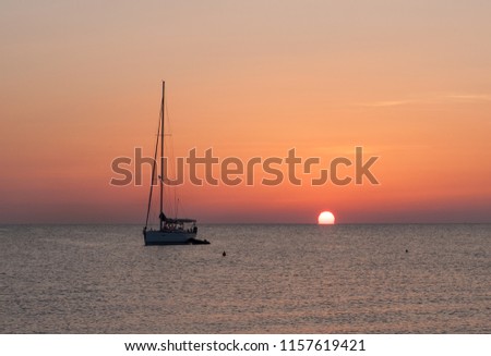 Rising sun and a boat