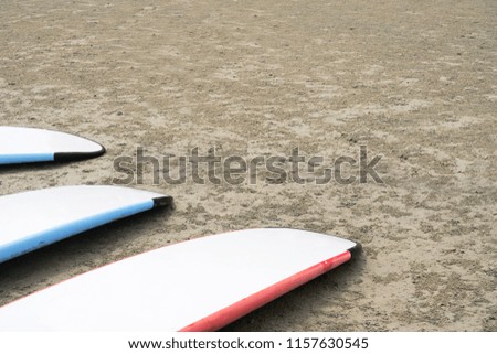Multi Surfboard on clear sand beach with copy space for content