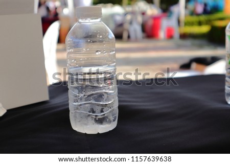 Plastic water bottles are placed on a black table.