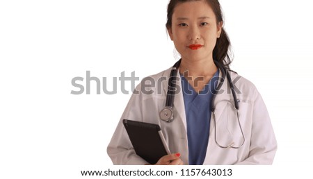 Professional female doctor carrying tablet pc looking at camera for copyspace
