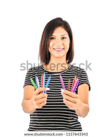 Happy female latin student holding crayons against a white background