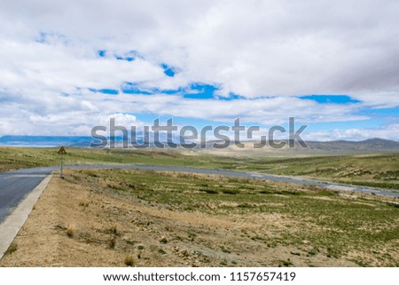 The area around sacred Manasarovar lake in the holy mountains of Tibet under cloudy sky. Ngari scenery in West Tibet. Sacred place for Buddha pupils. Place of prayer, calm and meditation.