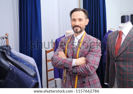 Portrait of mature tailor in atelier