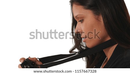 Side view of millennial woman taking picture with dslr on white background