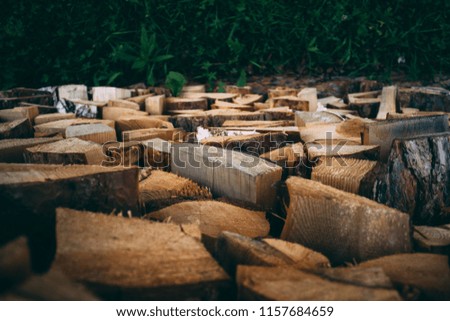 A large number of firewood from pine, neatly laid for later use. For a fireplace, stove or fire. Background, texture.