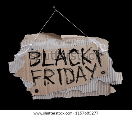 Cardboard sign on a cord and the inscription BLACK FRIDAY.
Ripped, corrugated paper hanging on cord with black handwritten sign BLACK FRIDAY.Isolated on black background.