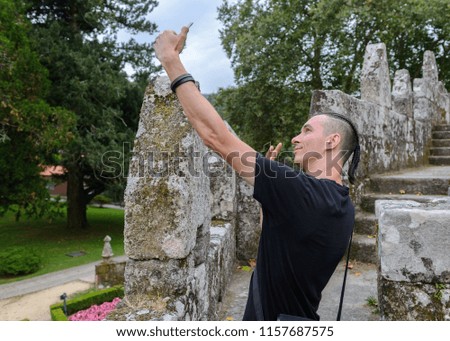 young man doing selfie on mobile phone