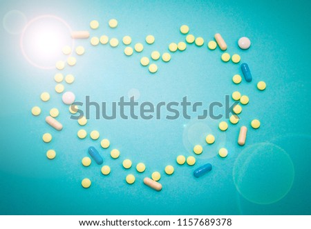 Happy love vitamin pills in blue background