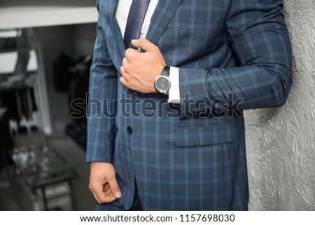 Young man in elegant suit near light wall Royalty-Free Stock Photo #1157698030
