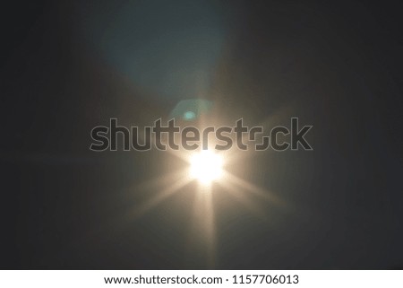 An artistic lens flare overlay with a semi warm glow.