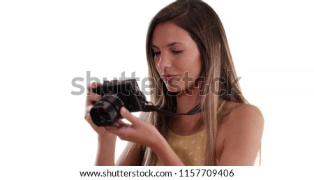 Happy Caucasian woman with camera taking photos on solid white copy space