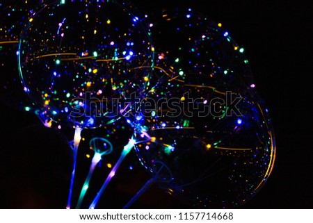 Colored lights on the balloons glow in the dark
