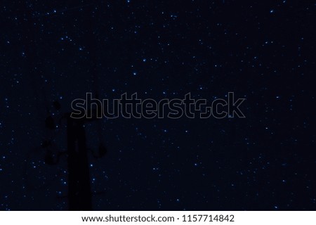 Long exposure night photo. A lot of stars with pillar on foreground. Far from the city.