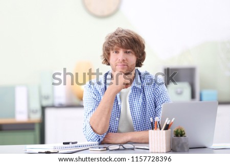 Portrait of stylish young man in office