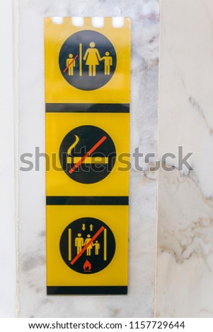 Yellow and black signs on a wall
