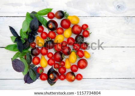 Colorful cherry tomatoes on wooden background