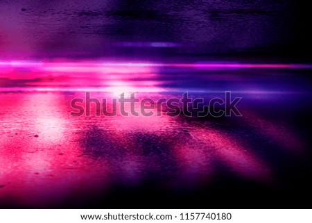 Background of empty room with spotlights and lights, abstract purple background with neon glow. Wet asphalt with reflection of lights, rain. Blurred Background