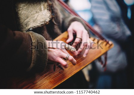 Womans hands while playing kokle - traditional Latvian music instrument Royalty-Free Stock Photo #1157740462