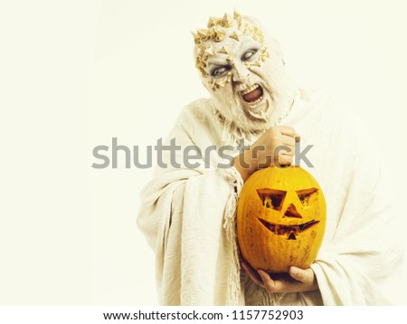halloween man with angry face hold orange pumpking on white background, copy space