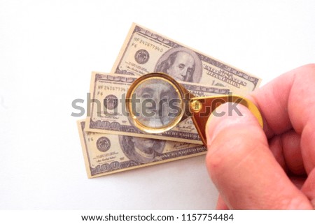 Souvenir hundred-dollar bills. Through the lens of a magnifying glass.
