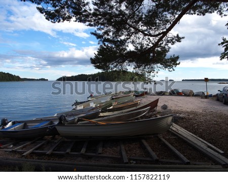 dirty and empty boats are parked by a sea shore on a blue sea, Espoo, Finland