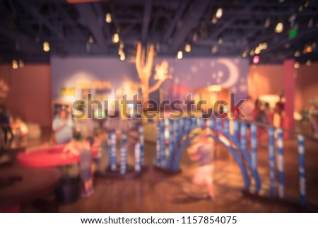 Blurred kids and parents playing at science educational museum in America