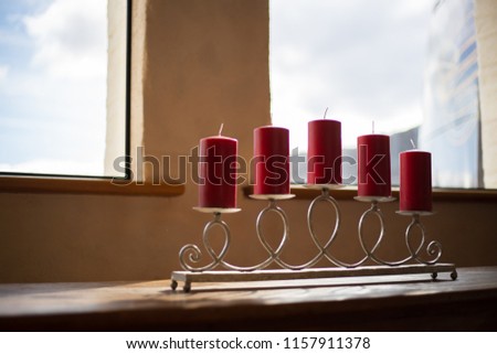 Red candles on candlesticks on table by the window sky backgroud Very high resolution of image