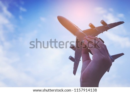 Small kid hands holding airplane
