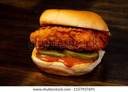 Tasty hot burger over wooden background