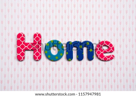 Word home from different colorful letters on stripe background.