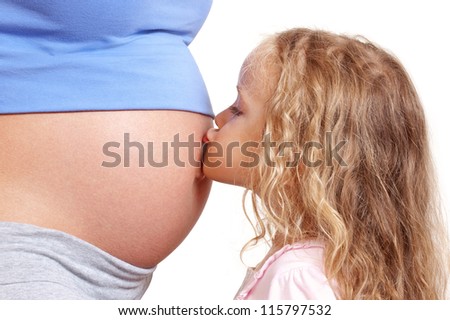 Little  girl kissing her pregnant mother belly