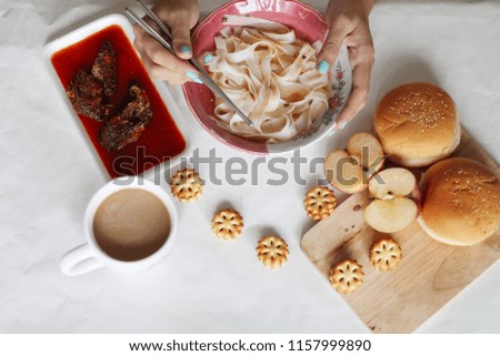 Breakfast, the modern asian way. A combination of the traditional dish like noodles and western influence like bread and biscuits