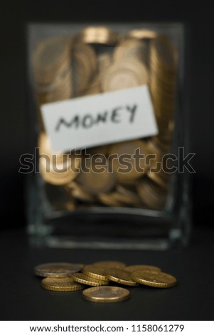money jar on black background