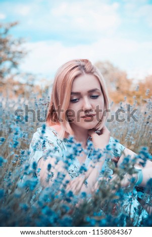 Beautiful girl on the lavender field. Boho style clothing and jewelry. Lovely girl in green bush. Blond girl with blue eyes in the garden. Portrait of a cute young girl in flowers.