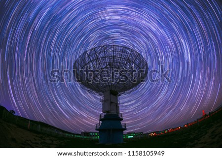 In observatories,satellite antenna radio telescope on the background of stellar tracks