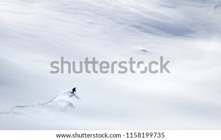 Aerial view of one skier off-piste skiing a bright white untouched vast powder snow field in Norway Royalty-Free Stock Photo #1158199735