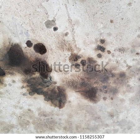 black engine oil stain on concrete road background