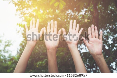 Hand up of female in garden nature and sunset background for voting,teamwork concept.