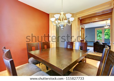 Dining room in red and blue and large wood table.