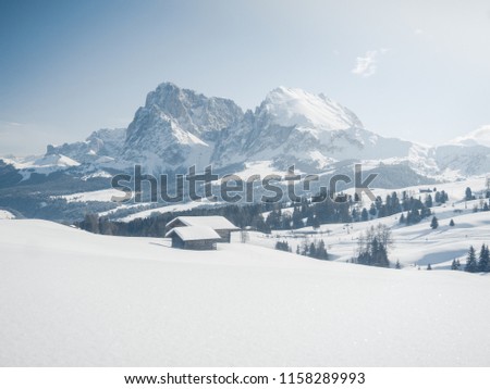 Wooden house Alpe di Siusi or Seiser Alm the Langkofel mountain range with Bolzano province, South Tyrol in Dolomites at Italy, Winter 2018